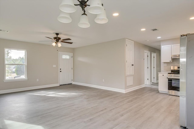 unfurnished living room featuring ceiling fan and light hardwood / wood-style floors