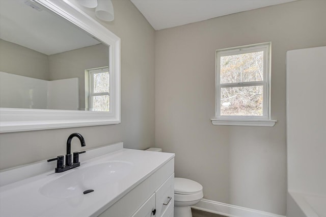 bathroom featuring vanity, toilet, and walk in shower