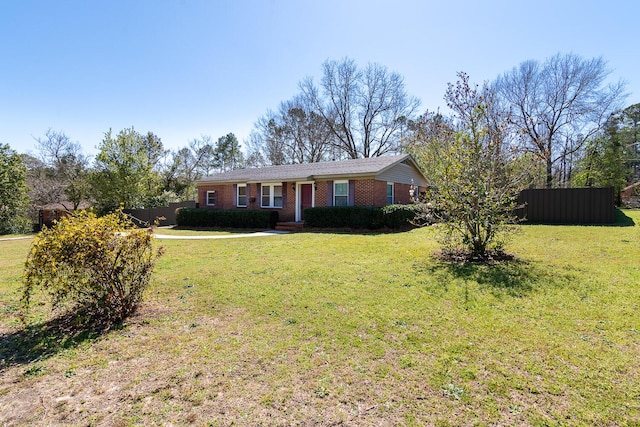 ranch-style house with brick siding, a front yard, and fence