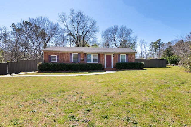 ranch-style home with a front yard, fence, and brick siding