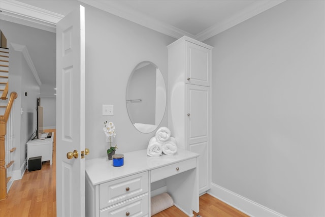 bathroom featuring wood-type flooring and ornamental molding