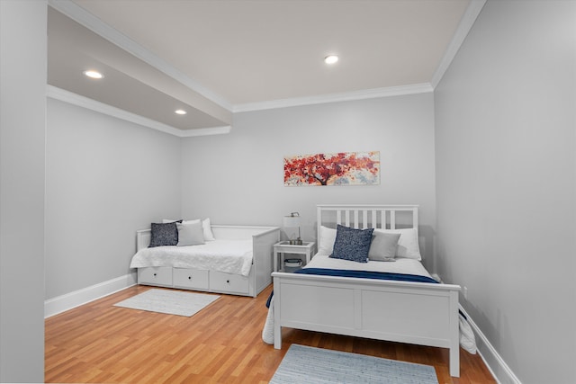 bedroom with hardwood / wood-style floors and crown molding