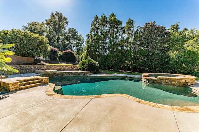 view of pool with an in ground hot tub and a patio