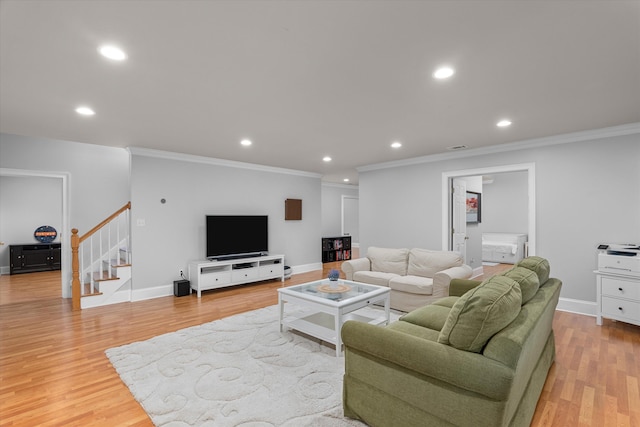 living room featuring light hardwood / wood-style flooring and crown molding