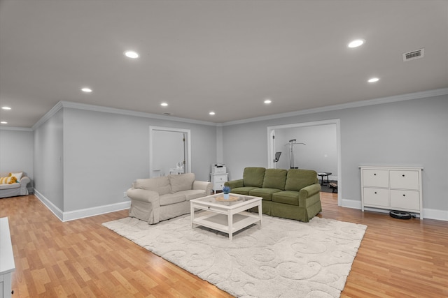 living room with crown molding and light hardwood / wood-style flooring