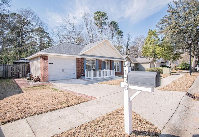 ranch-style house with an attached garage, covered porch, brick siding, fence, and driveway