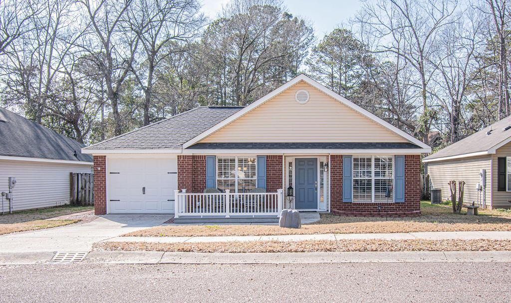 178 Redbud Dr, North Augusta, SC 29860 - view of front of home with driveway, an attached garage, covered porch, central AC, and brick siding