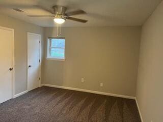 carpeted spare room with ceiling fan