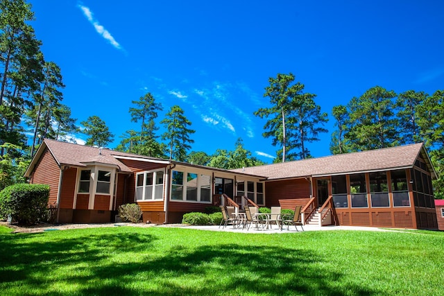 6287 Rousseau Creek Rd, Thomson, GA 30824 - back of property with a sunroom, a lawn, a patio, a shingled roof, and entry steps