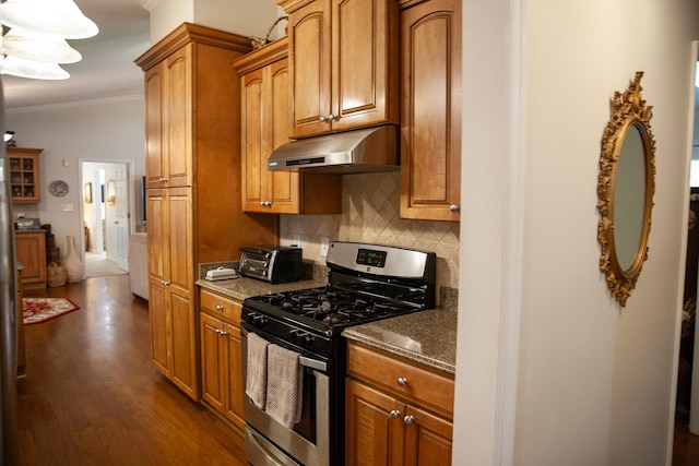 6287 Rousseau Creek Rd, Thomson, GA 30824 - kitchen with stainless steel range with gas stovetop, under cabinet range hood, crown molding, backsplash, and dark wood-type flooring
