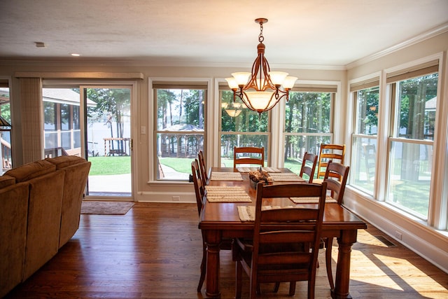 6287 Rousseau Creek Rd, Thomson, GA 30824 - dining area featuring a chandelier, plenty of natural light, ornamental molding, and dark wood-style floors