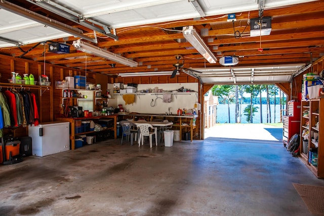 6287 Rousseau Creek Rd, Thomson, GA 30824 - garage with a workshop area and a garage door opener