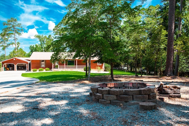 6287 Rousseau Creek Rd, Thomson, GA 30824 - view of front of home featuring a fire pit, a front lawn, and a porch