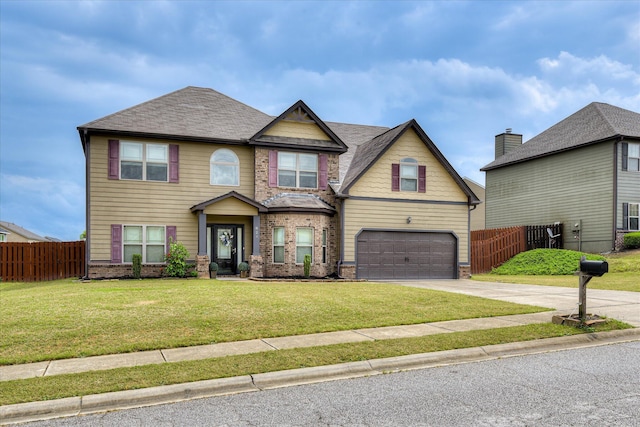 craftsman house with a garage, fence, a front yard, and concrete driveway