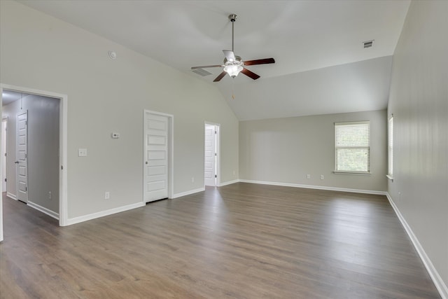 interior space with visible vents, baseboards, vaulted ceiling, dark wood finished floors, and a ceiling fan