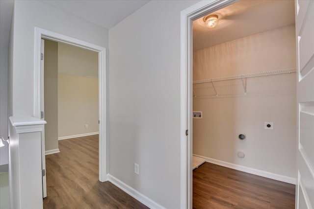 laundry area with electric dryer hookup, baseboards, laundry area, and dark wood-style floors