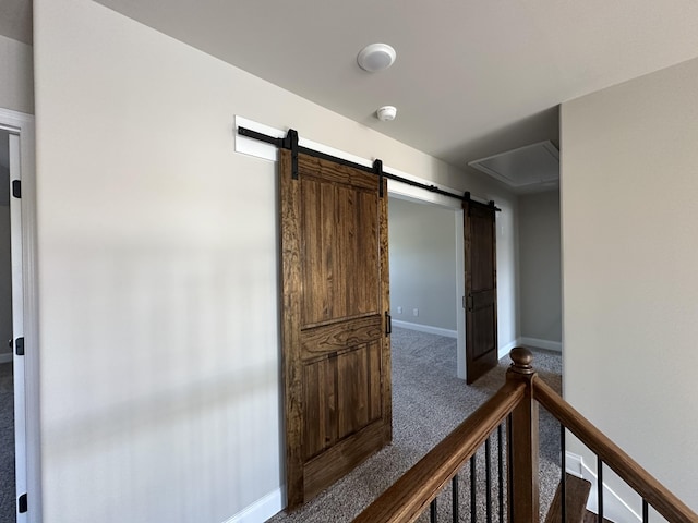 2417 Laurens St, Grovetown, GA 30813 - hallway with dark colored carpet, a barn door, and baseboards