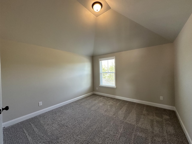 2417 Laurens St, Grovetown, GA 30813 - spare room featuring vaulted ceiling, dark colored carpet, and baseboards