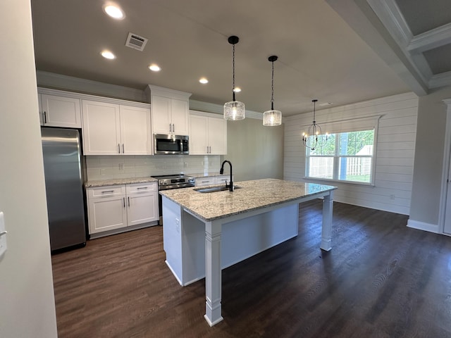 2417 Laurens St, Grovetown, GA 30813 - kitchen featuring appliances with stainless steel finishes, a sink, ornamental molding, white cabinets, and a center island with sink