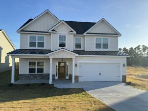 2417 Laurens St, Grovetown, GA 30813 - craftsman-style house featuring a standing seam roof, concrete driveway, a garage, metal roof, and covered porch