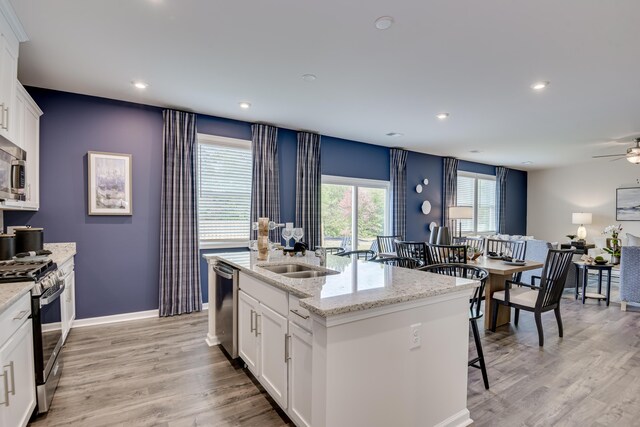 2027 Saylor Ln, Grovetown, GA 30813 - kitchen with stainless steel appliances, ceiling fan, light wood-type flooring, white cabinets, and recessed lighting