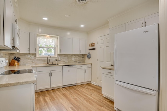4073 Old Trail Rd, Augusta, GA 30907 - kitchen with white appliances, crown molding, tasteful backsplash, light countertops, and light wood-style flooring