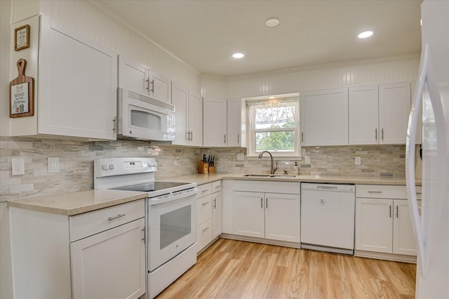 4073 Old Trail Rd, Augusta, GA 30907 - kitchen with white appliances, ornamental molding, backsplash, light countertops, and white cabinetry