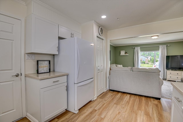 4073 Old Trail Rd, Augusta, GA 30907 - kitchen featuring freestanding refrigerator, open floor plan, ornamental molding, light wood-style floors, and light countertops
