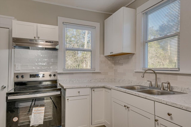 kitchen with sink, white cabinets, backsplash, electric range, and light stone countertops