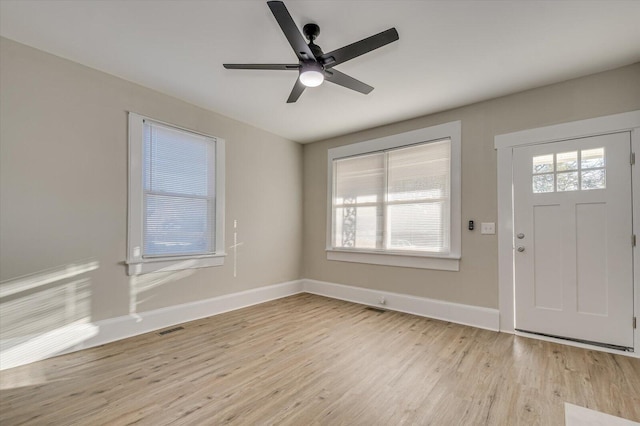 foyer entrance with ceiling fan and light hardwood / wood-style floors