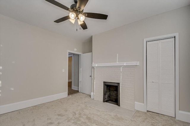 unfurnished living room with ceiling fan, light carpet, and a brick fireplace