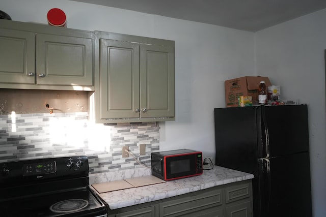 kitchen featuring black appliances and decorative backsplash