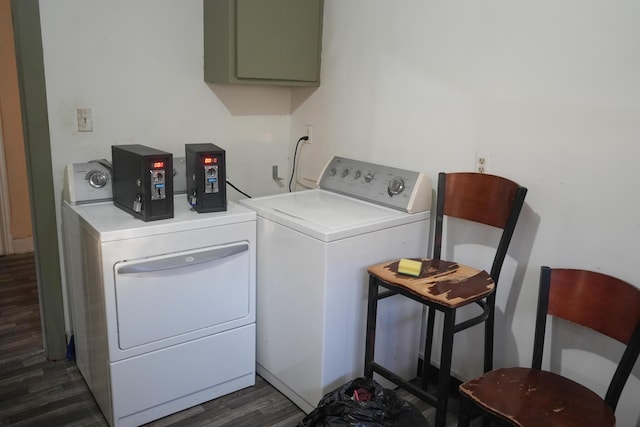 laundry room with dark hardwood / wood-style floors and washing machine and clothes dryer