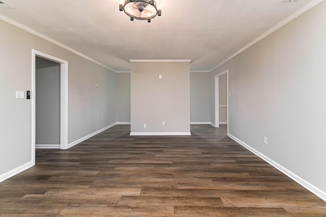 spare room featuring dark hardwood / wood-style flooring and crown molding