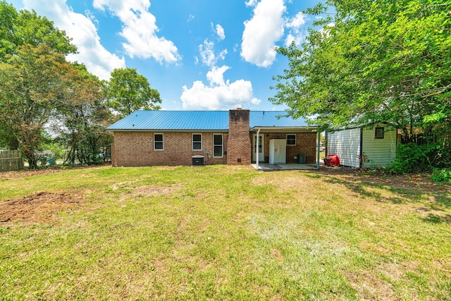 back of house featuring a yard and central AC unit