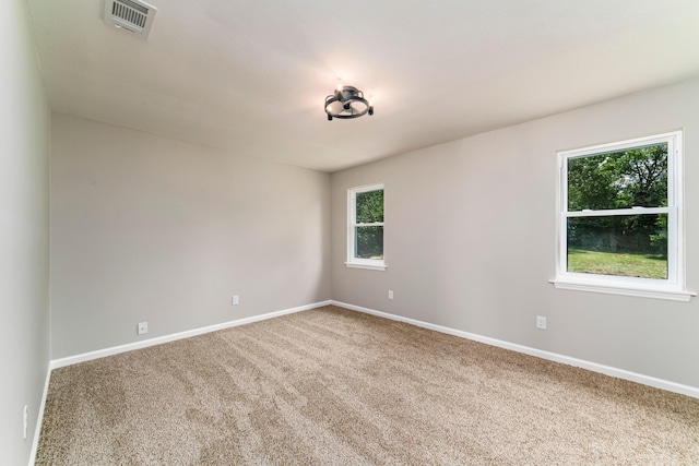 unfurnished room with plenty of natural light and carpet