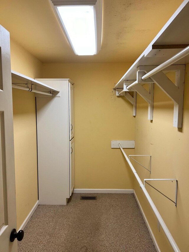 walk in closet featuring carpet