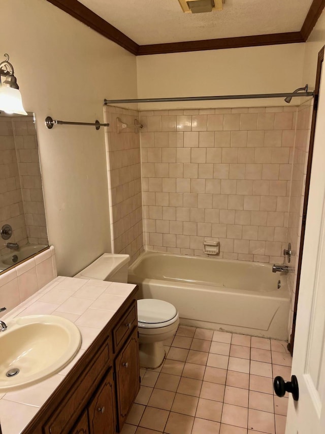 full bathroom featuring vanity, tile patterned floors, crown molding, tiled shower / bath, and toilet