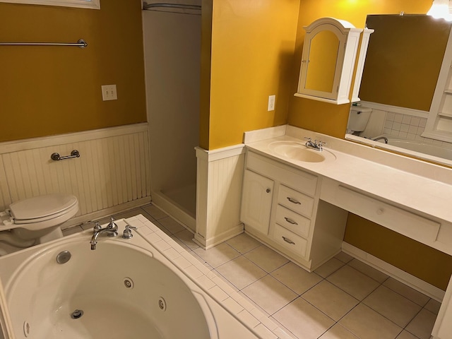 bathroom featuring vanity, tile patterned flooring, a bathtub, and toilet