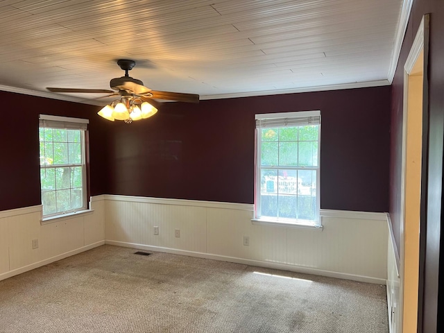 carpeted spare room featuring ceiling fan and ornamental molding