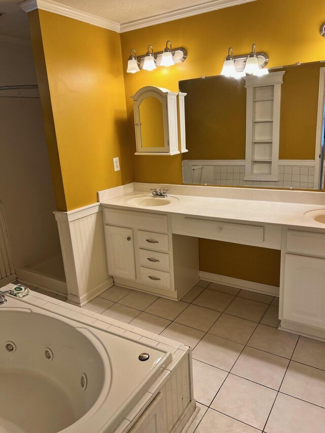 bathroom with tile patterned floors, a washtub, ornamental molding, and vanity