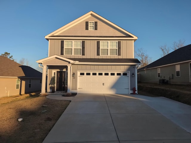 view of front property featuring cooling unit and a garage