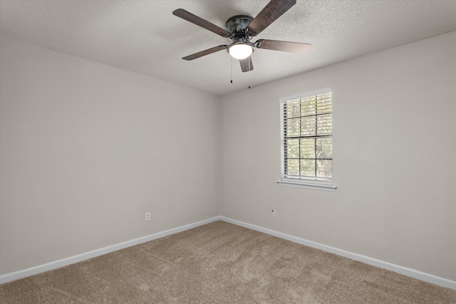 unfurnished room featuring carpet flooring, baseboards, a ceiling fan, and a textured ceiling