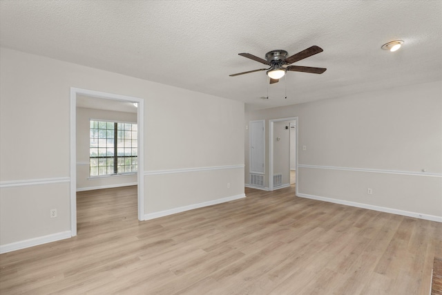 unfurnished room featuring baseboards, light wood finished floors, a textured ceiling, and a ceiling fan