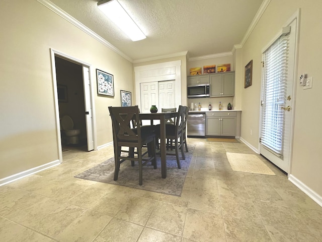 dining area featuring a textured ceiling and ornamental molding