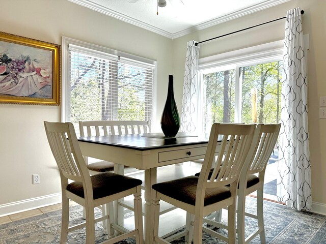 dining space with tile patterned floors, ceiling fan, and ornamental molding