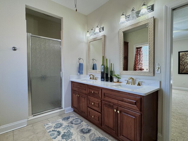 bathroom featuring tile patterned flooring, vanity, and a shower with door