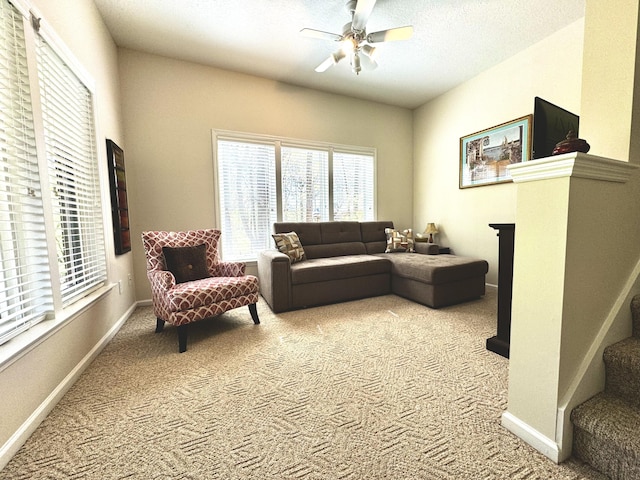 carpeted living room with ceiling fan