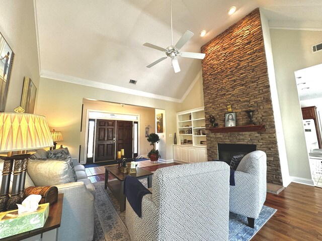 living room featuring dark wood-type flooring, high vaulted ceiling, ceiling fan, built in features, and a fireplace