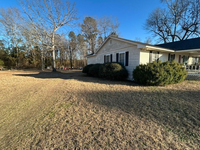 view of home's exterior featuring a yard and covered porch